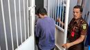 Petugas kantor kejaksaan mengawal dua orang terdakwa pasangan sejenis (gay) untuk menjalani persidangan di pengadilan syariah di Banda Aceh (17/5). (AP Photo/Heri Juanda)