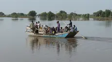 Penduduk desa dievakuasi dengan perahu dari daerah banjir dekat kota Burewala, di distrik Vehari di provinsi Punjab, pada 25 Agustus 2023. (AFP/Shahid Saeed Mirza)