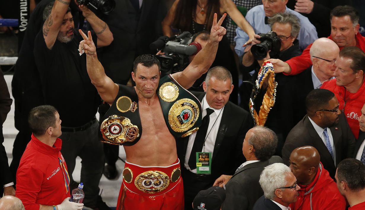 Wladimir Klitschko merayakan keberhasilannya mempertahankan gelar juara usai menang angka dari Bryant Jennings di Madison Square Garden, Minggu (26/4/2015). (AP Photo/Frank Franklin II)