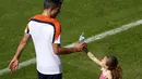 Penyerang Timnas Belanda, Robin van Persie, terlihat menerima air minum dari putrinya, Dina, usai berlatih dan bermain di Rio de Janeiro, (24/6/2014). (REUTERS/Ricardo Moraes)