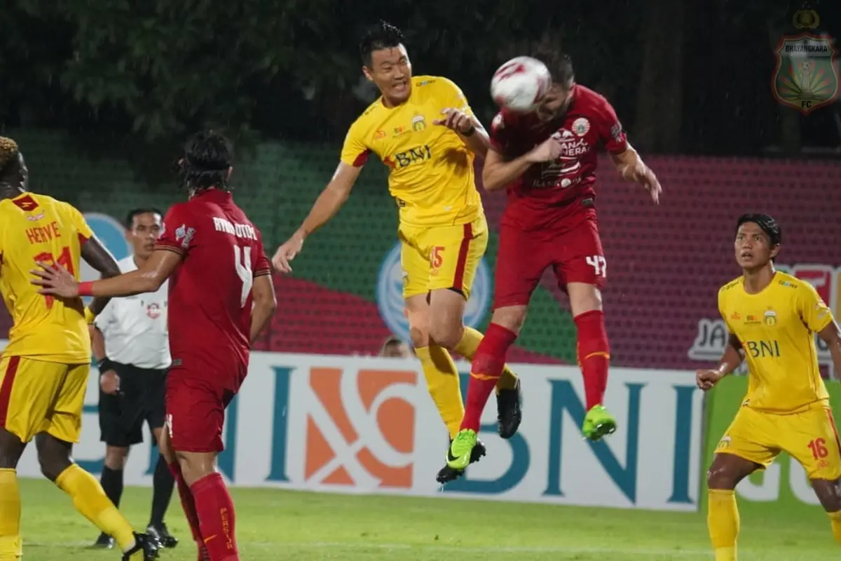Bek Bhayangkara FC, Lee Won-jae berduel dengan bek Persija, Marco Motta.