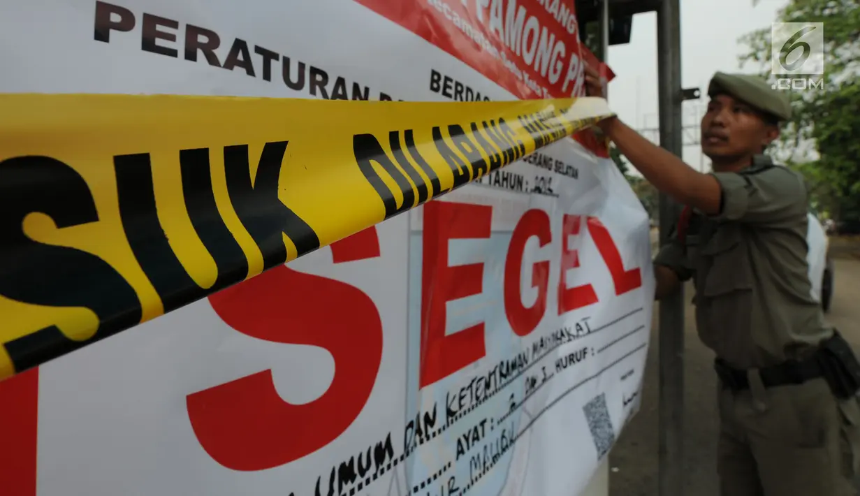 Satuan Polisi Pamong Praja (Satpol PP) Kota Tangerang Selatan menyegel areal parkir liar di kawasan BSD, Rabu (3/10). Penyegelan tersebut dilakukan lantaran pihak pengelola parkir tidak memiliki izin. (Merdeka.com/Arie Basuki)