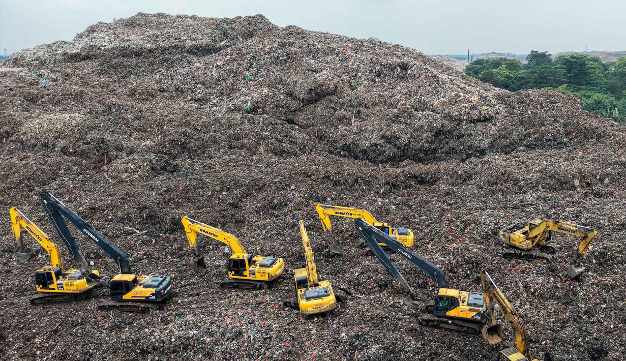 Diketahui, Zona 4 TPST Bantargebang merupakan area dengan tumpukan sampah dengan ketinggian puluhan meter yang setara dengan tinggi gedung 17 lantai). Tampak foto udara menunjukkan tim penyelamat menggunakan alat berat untuk mencari korban longsor di Tempat Pembuangan Sampah Terpadu (TPST) Bantargebang, Bekasi, Jawa Barat, pada 9 Maret 2026. (BAY ISMOYO/AFP)
