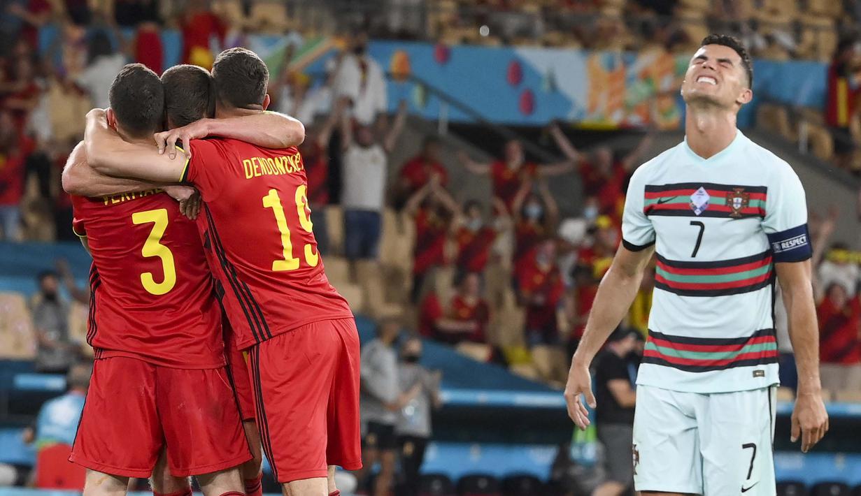 Ekspresi kecewa Cristiano Ronaldo (kanan) usai Belgia merayakan kemenangan atas Portugal dalam pertandingan babak 16 besar Euro 2020 antara Belgia dan Portugal di stadion La Cartuja, Seville, Spanyol, Minggu, (27/6/2021). (Foto: AP/Pool/Lluis Gene)