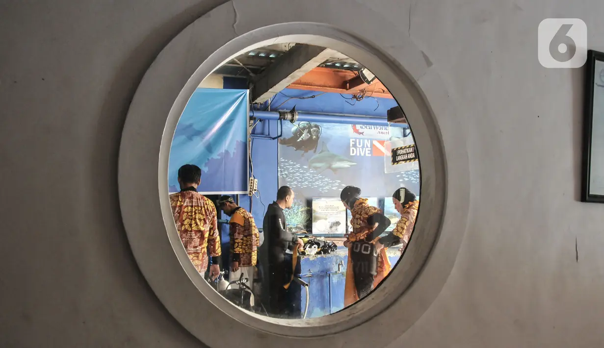 Penyelam mengenakan busana batik saat bersiap sebelum tampil untuk pertunjukan bawah air dalam rangka menyambut Hari Batik Nasional di Sea World Ancol, Jakarta Utara, Rabu (28/9/2022). Sea World Ancol menggelar pertunjukkan bertajuk "Pekan Kolaborasi Budaya dan Sejarah" untuk menyambut peringatan Hari Batik Nasional Tahun 2022 yang akan berlangsung pada tanggal 1-9 Oktober 2022 dengan menampilkan fashion show, tarian tradisional serta atraksi bawah air. (merdeka.com/Iqbal S. Nugroho)