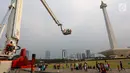 Pengunjung menaiki Bronto Skylift yang disediakan petugas pemadam kebakaran di Monas, Jakarta, Minggu (23/11). Bronto Skylift merupakan fasilitas yang disediakan Pemprov DKI Jakarta untuk melihat Monas dari dekat. (Liputan6.com/JohanTallo)