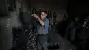 Pria Palestina Mohammed Al-Skafi mengolah sebuah ban kendaraan bekas untuk membuat keranjang penyimpanan di bengkel kerjanya di Kota Hebron, Tepi Barat (10/11/2020). Pria 68 tahun itu membuat dan menjual ember, ikat pinggang, dan keranjang penyimpanan dari ban bekas. (Xinhua/Mamoun Wazwaz)