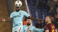Bek Barcelona, Samuel Umtiti, menyundul bola saat melawan AS Roma pada laga leg kedua perempat final Liga Champions, di Stadion Olimpico, Selasa (10/4/2018). AS Roma menang 3-0 atas Barcelona. (AP/Gregorio Borgia)