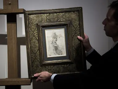 Seorang anggota Rumah Lelang Tajan menyiapkan gambar sketsa karya Leonardo da Vinci sebelum dilelang di Paris, Prancis (13/12). Leonardo da Vinci adalah seorang seniman yang dikenal dengan lukisan 'Mona Lisa'. (AFP/Philippe Lopez)
