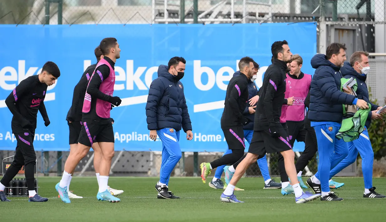 Pelatih Barcelona Xavi (tengah) dan para pemainnya mengambil bagian dalam sesi latihan di Barcelona pada 16 Februari 2022. Barcelona bakal meladeni Napoli pada leg pertama play-off babak gugur Liga Europa 2021/22 di Camp Nou, Jumat 18 Februari 2022. (LLUIS GENE / AFP)