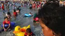 Pengunjung bermain dan berenang di kawasan Beach Pool, Taman Impian Jaya Ancol, Jakarta, Kamis (6/6/2019). Hari kedua Lebaran banyak dimanfaatkan warga untuk berlibur dan berekreasi bersama keluarga atau kerabat dengan mengunjungi pantai Ancol. (Liputan6.com/Johan Tallo)