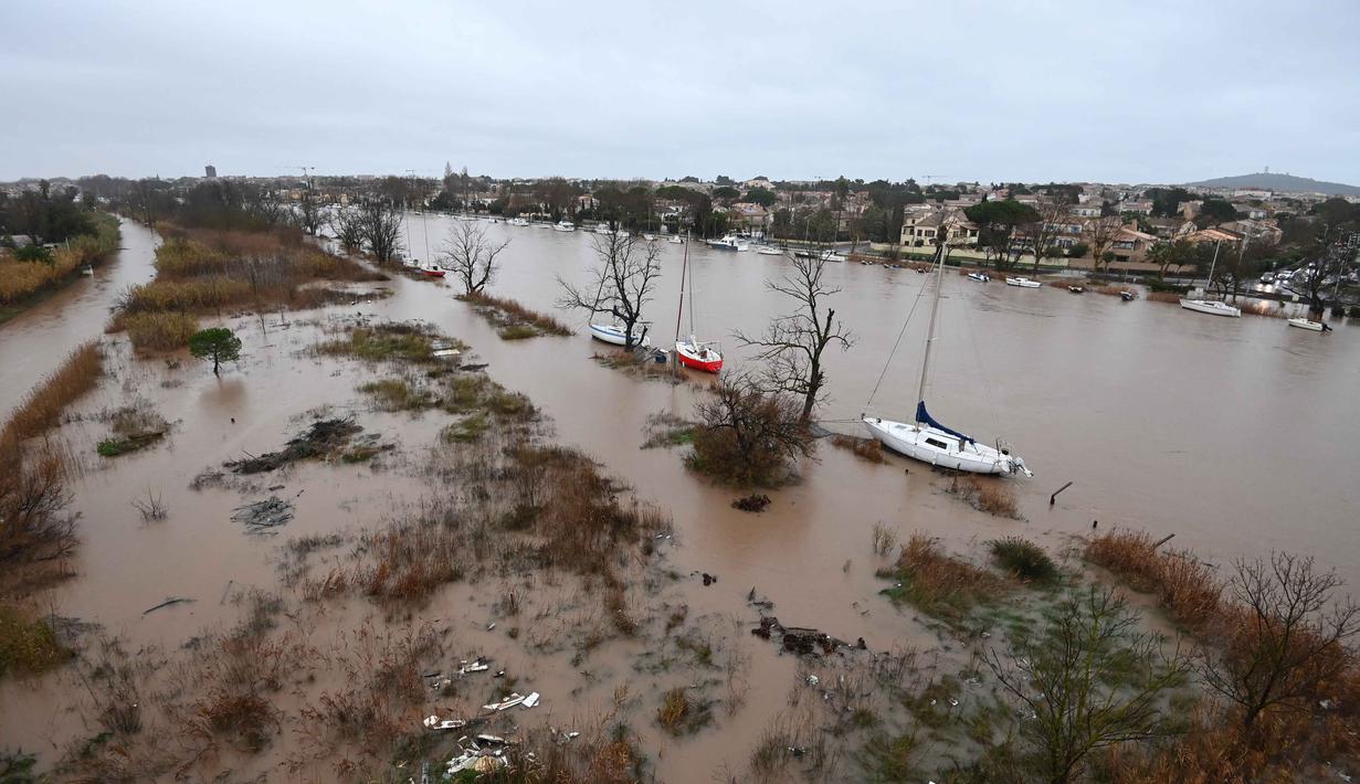 Luapan sungai juga merendam wilayah Agde dengan tingkat ketinggian air yang dilaporkan belum pernah terjadi lagi sejak tahun 1994. Tampak foto yang menunjukkan pemandangan umum Sungai Herault yang meluap setelah hujan lebat di Agde, Prancis selatan pada Selasa 23 Desember 2025. (Sylvain THOMAS/AFP)