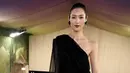 Model asal China, Liu Wen terlihat mengenakan dress Saint Laurent satu bahu berwarna hitam yang elegan, dipadukan dengan anting-anting piramida persegi dan slingback dari label tersebut. [@liuwenlw]