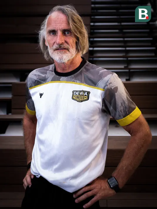 <p>Pelatih Dewa United, Jan Olde Riekerink berpose di depan fotografer setelah melakukan sesi wawancara di basecamp Dewa United, Pagedangan, Tangerang, Selasa (18/07/2023). (Bola.com/Bagaskara Lazuardi)</p>