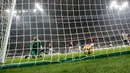 Kiper AC Milan, Gianluigi Donnarumma mengamati bola yang gagal ditangkapnya dalam lanjutan Serie A Italia melawan Juventus di Stadion San Siro, Sabtu (28/10). Dua gol Si Nyonya Tua diborong striker Gonzalo Higuain. (AP/Luca Bruno)