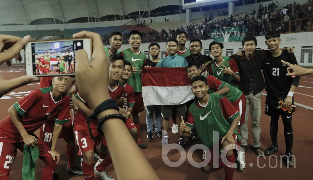 Pemain Timnas Indonesia U-16 foto bersama suporter usai pertandingan melawan Singapura pada laga uji coba di Stadion Wibawa Mukti, Cikarang, Kamis, (8/6/2017). Indonesia menang 4-0. (Bola.com/M Iqbal Ichsan)
