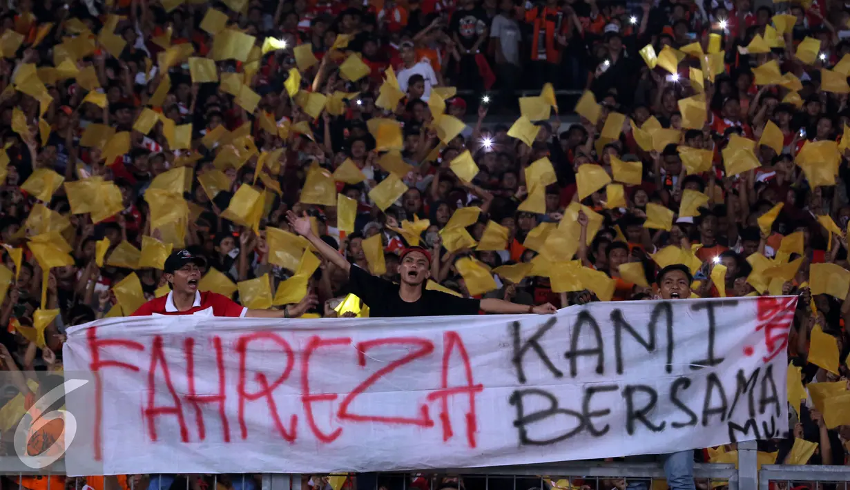 Suporter spanduk duka jelang menyaksikan laga Persija melawan PS TNI di Stadion GBK Jakarta, Jumat (10/6). Ungkapan duka ditujukan atas tewasnya M Fahreza saat akan menyaksikan laga Persija(13/5) lalu. (Liputan6.com/Helmi Fithriansyah)