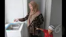 Seorang wanita saat mengecek air di dalam rumah susun sederhana sewa (rusunawa) Tambora seusai diresmikan Gubernur DKI Jakarta Basuki Tjahaja Purnama, Jakarta, Selasa (24/2/2015). (Liputan6.com/Herman Zakharia)