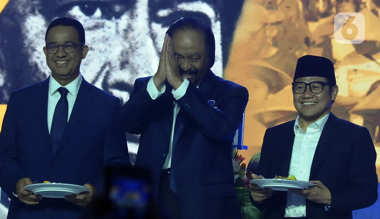 Ketua Umum Partai Nasional Demokrat (Nasdem) Surya Paloh (tengah) saat memberikan tumpeng kepada calon presiden dan calon wakil presiden Koalisi Perubahan, Anies Baswedan (kiri) - Muhaimin Iskandar (Kanan) di Kantor DPP Partai Nasdem, Jakarta, Sabtu (11/11/2023). (merdeka.com/Imam Buhori)