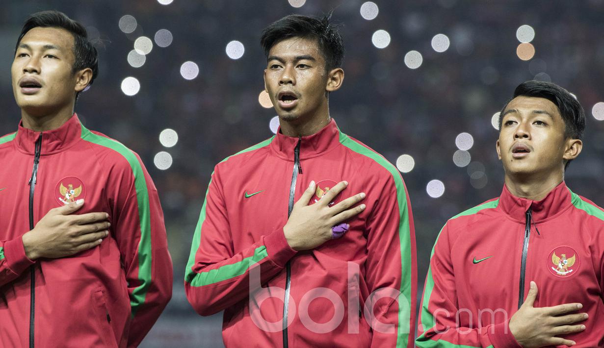 Kiper Timnas Indonesia U-22, Satria Tama (tengah), bernyanyi lantang saat lagu Indonesia Raya berkumandang sebelum uji coba melawan Persija. Kesempatan bermain untuk Merah Putih memberikan kebanggaan bagi mereka. (Bola.com/Vitalis Yogi Trisna) 