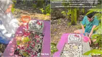 Tak sempat memanjakan semasa masih hidup, pasangan suami istri ini hias makam sang anak dengan kartun Hello Kitty. (Sumber: TikTok/@helsaseftini)