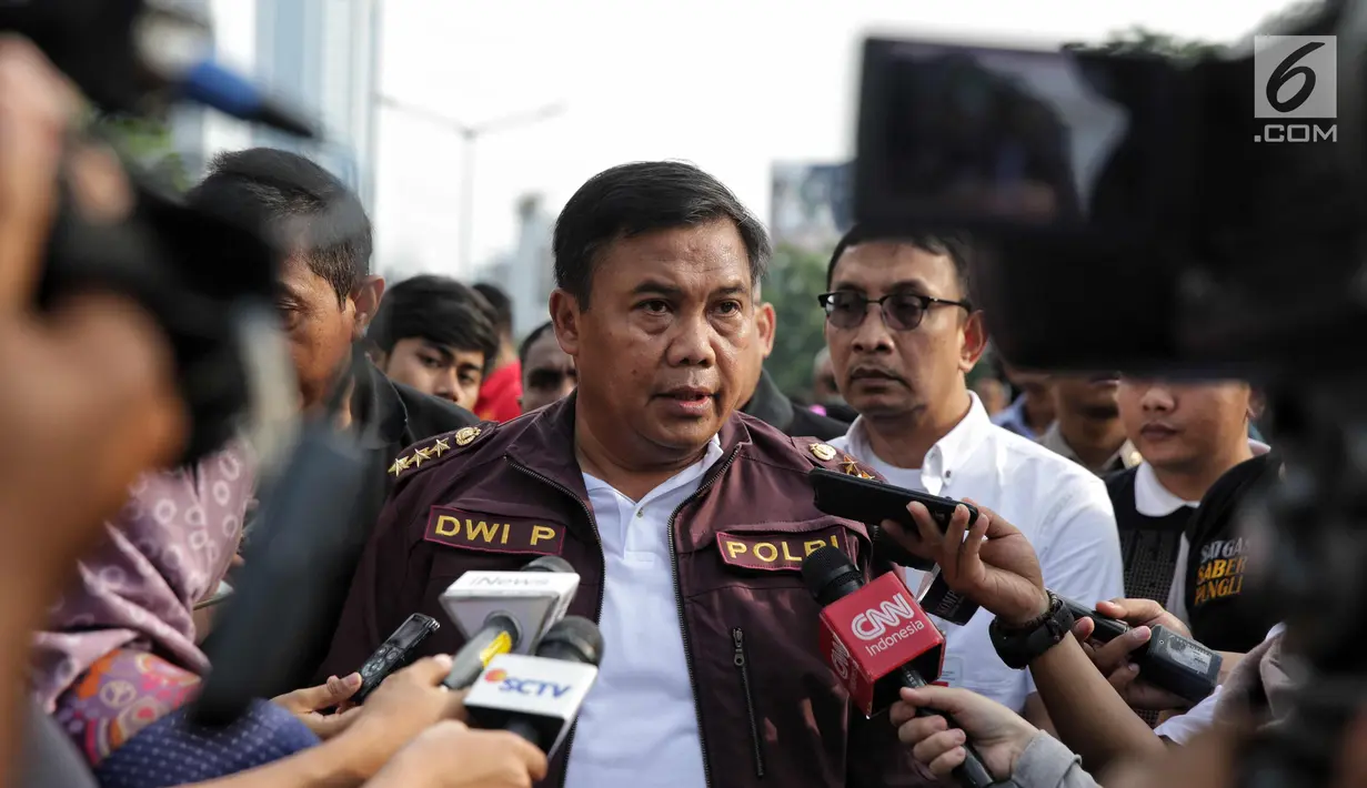 Kepala Pelaksana Satgas Saber Pungli Komjen Pol Dwi Priyatna memberikan keterangan kepada awak media usai menghadiri sosialisasi satgas saber punglis di Car Free Day, Jakarta, Minggu (12/11). (Liputan6.com/Faizal Fanani)