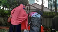 Peserta aksi tengah membersihkan sampah sisa masyarakat yang berdemonstrasi di Kedubes Myanmar. (Liputan6.com/Ika Defianti)