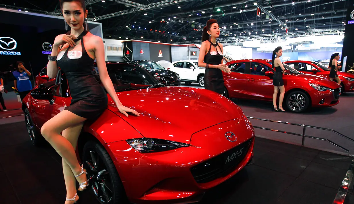 Model berpose di samping mobil Mazda MX-5  selama Bangkok Internasional Motor Show 2016  di Thailand, (22/3). BIMS 2016 mengusung tema "No Boundaries Mobility". (REUTERS / Chaiwat Subprasom)