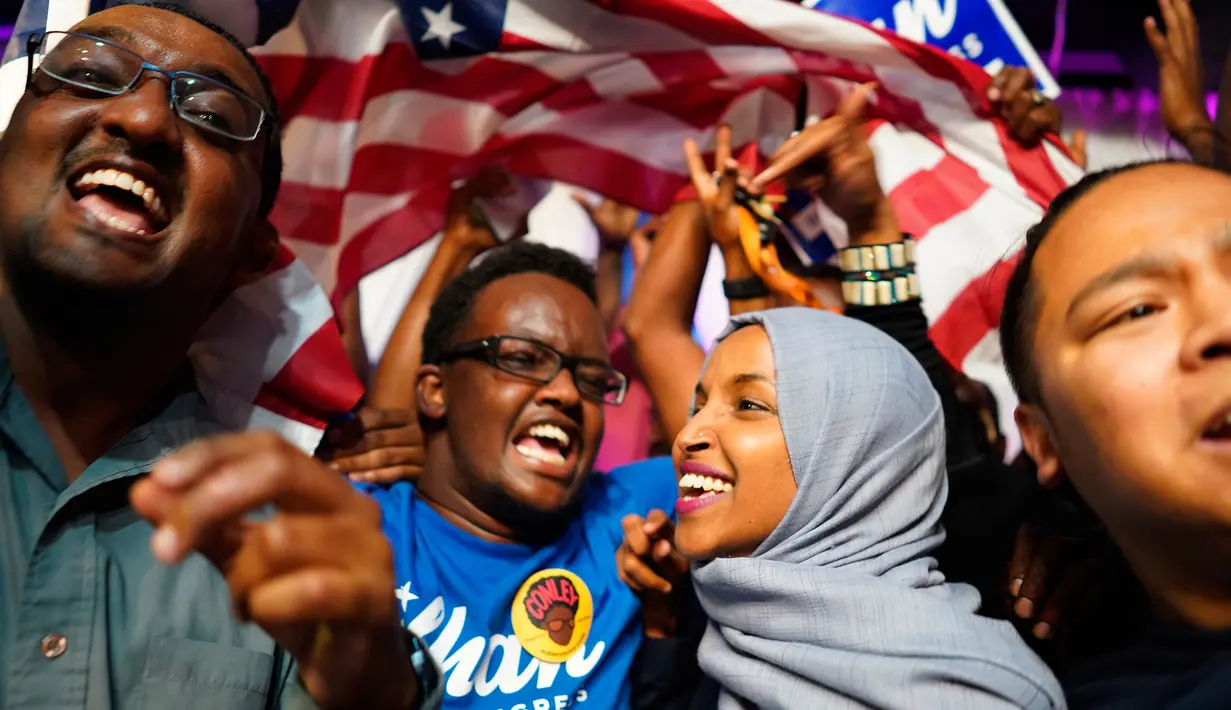 Ilhan Omar bersama pendukungnya merayakan kemenangan putaran pertama pemilihan Distrik Kongres ke-5 di Minneapolis, AS, Selasa (14/8). Omar diprediksi akan menang dalam pemilihan penuh pada November nanti. (Mark Vancleave/Star Tribune via AP)