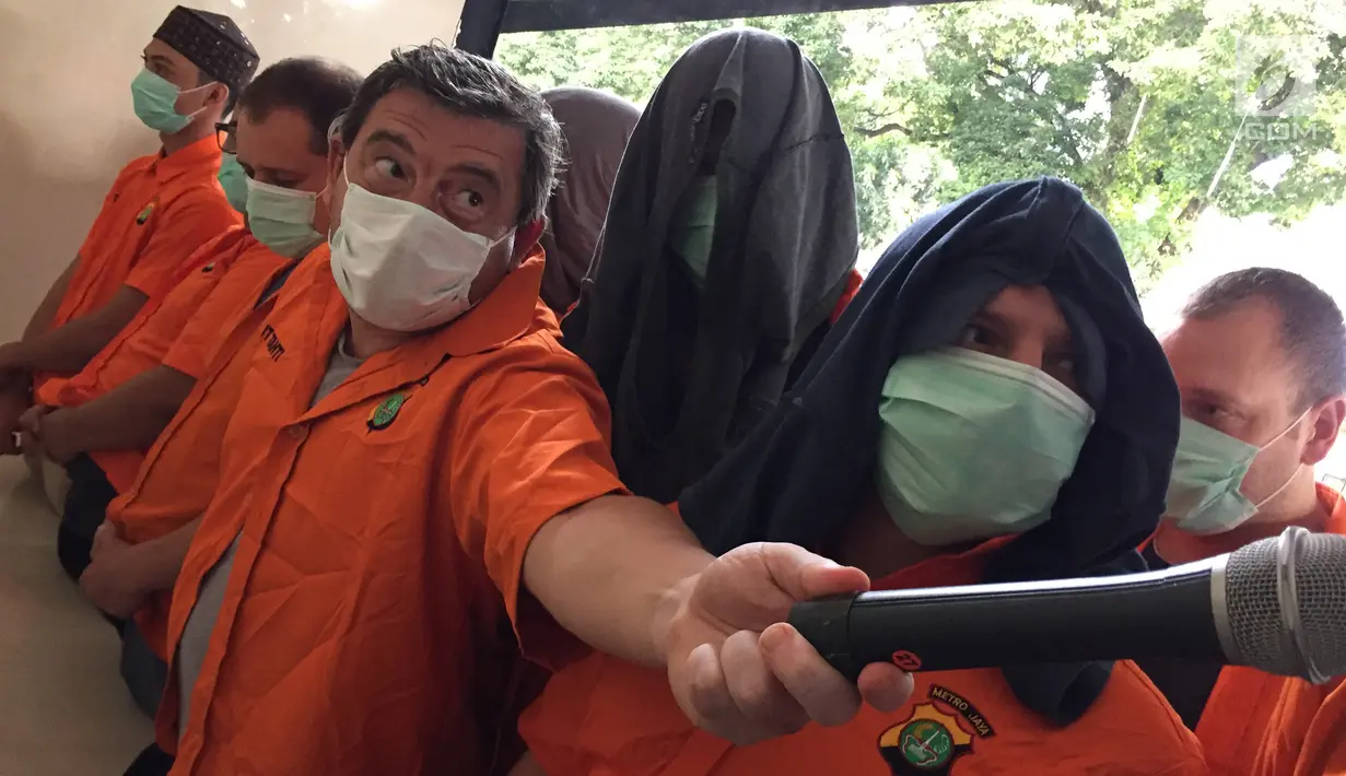 Sejumlah tersangka kasus pemalsuan, pencurian data elektronik, dan tindak pidana pencucian uang ditampilkan di Polda Metro Jaya, Jakarta, Senin (18/12). (Liputan6.com/Immanuel Antonius)