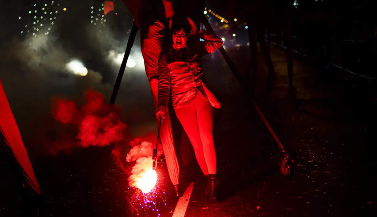 Para peserta menari saat parade Cabalgata de Reyes di Madrid, Spanyol, 5 Januari 2022. Parade warna-warni ini dalam rangka merayakan Epiphany saat umat Kristen memperingati kunjungan Tiga Raja atau Tiga Orang Bijaksana ke bayi Yesus. (AP Photo/Bernat Armangue)