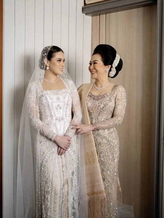 Saat pemberkatan, Chen mengenakan kebaya putih panjang berpayet dari Myrna Myura. Dipadukan bawahan songket kekuningan dari Merdi Sihombing. Lengkap dengan veilnya. [@myrnamyura]