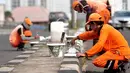 Petugas penanganan prasarana dan sarana umum (PPSU) sedang mengecat  kembali  trotoar di Kawasan Jakarta, Selasa (1/8). Pengecatan dilakukan dalam rangka mempercantik wilayah yang disinergikan dengan menyambut HUT RI ke-72. (Liputan6.com/Helmi Afandi)