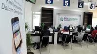 Petugas melayani warga yang mengurus iuran BPJS Kesehatan di Kantor BPJS Jalan Raya Pasar Minggu, Jakarta, Senin (4/11/2019). Perhimpunan Rumah Sakit Seluruh Indonesia memprediksi akan terjadi migrasi turun kelas pada peserta akibat kenaikan iuran 100 persen pada awal 2020. (merdeka.com/Arie Basuki)