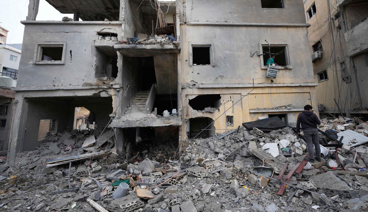 Sejumlah permukiman warga Lebanon juga menjadi sasaran serangan udara Israel. Tampak dalam foto, seorang pria memeriksa bangunan yang hancur akibat serangan udara Israel di kota pelabuhan Tyre, Lebanon selatan, Kamis, 26 Maret 2026. (AP Photo/Hussein Malla)