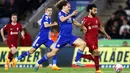 Striker Liverpool, Mohamed Salah (kanan) berusaha melewati bek Leicester City, Wout Faes pada laga Liga Inggris 2022/2023 di King Power Stadium, Licester (15/5/2023). Mohamed Salah yang kini menjalani musim ke-6 bersama Liverpool menjadi pemain terbaru alias keempat yang sukses mencetak hattrick assist di Liga Inggris pada musim 2022/2023. Momen itu terjadi di pekan ke-36 saat Liverpool menang 3-0 atas Leicester City. (AFP/Darren Staples)