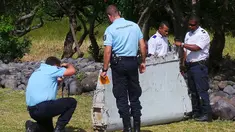 Polisi berdiri dekat potongan mirip badan pesawat di pantai Saint - Andre, Perancis, Rabu  (29/30/2015). Lembaga investigasi Perancis akan berkoordinasi dengan pemerintah Malaysia dan Australia apa itu dari Malaysia Airlines MH370. (REUTERS/Prisca Bigot)