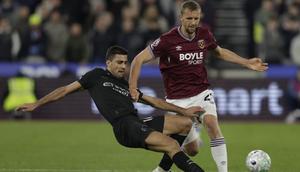 Gelandang Manchester City, Rodri, berupaya merebut bola dari kaki pemain West Ham United, Tomas Soucek, pada laga pekan ke-30 Premier League di London Stadium, Minggu (15/03/2026) dini hari WIB. Sayangnya, Rodri gagal membawa Man City meraih kemenangan, setelah hanya mampu bermain imbang 1-1. (AFP/Ian Kington)
