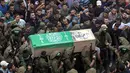 Tentara Hamas mengenakan topeng dan membawa senjata mengiringi peti jenazah enam pejuang mereka yang tewas di Deir el-Balah, Jalur Gaza (6/5). Di sisi lain, pihak militer Israel membantah terlibat dalam ledakan tersebut. (AP/Khalil Hamra)