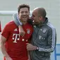 Pelatih Bayern Munchen, Josep Guardiola (kanan) bercanda dengan gelandang Xabi Alonso, pada sesi latihan di Doha, Qatar, beberapa waktu lalu. Guardiola pesimis timnya bisa menuai trofi Liga Champions 2015-2016. (EPA/Andreas Gebert)