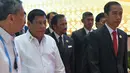 Presiden Filipina Rodrigo Duterte dan Presiden Indonesia Joko Widodo berjalan menuju tempat sidang paripurna KTT ASEAN di Vientiane (6/9). (AFP PHOTO/Roslan Rahman)