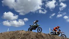 Dua pembalap Crosser MX2 melewati obstacle di Sirkuit Samota, Sumbawa, NTB. Sirkuit ini dikenal sebagai venue yang memiliki obstacles lengkap. (Bola.com/Wiwig Prayugi)