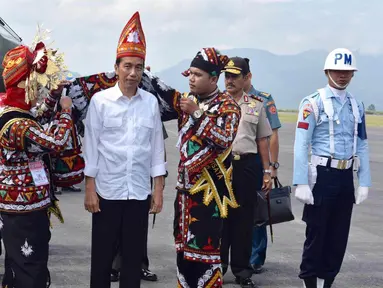 Presiden Jokowi menerima topi raja dan kain ulen-ulen khas Aceh bermotif Kerawang Gayo saat tiba di Bandara Rembele, di Kabupaten Bener Meriah, Provinsi Aceh, Rabu (2/3). Kedatangan Presiden dan rombongan untuk meresmikan Bandara Rembele. (Foto : Setpres)