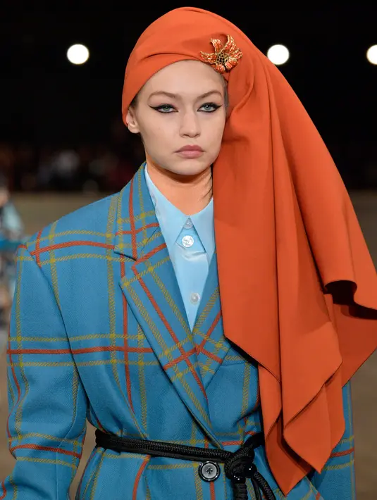 Model cantik, Gigi Hadid berjalan di catwalk mengenakan koleksi Marc Jacobs Spring/Summer 2018 selama New York Fashion Week, Rabu (13/9). Gigi Hadid mengenakan mantel oversized dan rok selutut warna biru dengan motif garis (SLAVEN VLASIC/GETTY IMAGES/AFP)