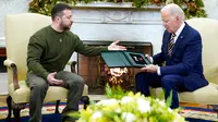 Presiden Ukraina Volodymyr Zelenskyy berbicara setelah memberikan hadiah kepada Presiden Amerika Serikat Joe Biden saat mereka bertemu di Oval Office Gedung Putih, Washington, Amerika Serikat, 21 Desember 2022. Kunjungan ke AS adalah perjalanan pertama Zelenskyy ke luar negaranya sejak invasi Rusia pada Februari. (AP Photo/Patrick Semansky)