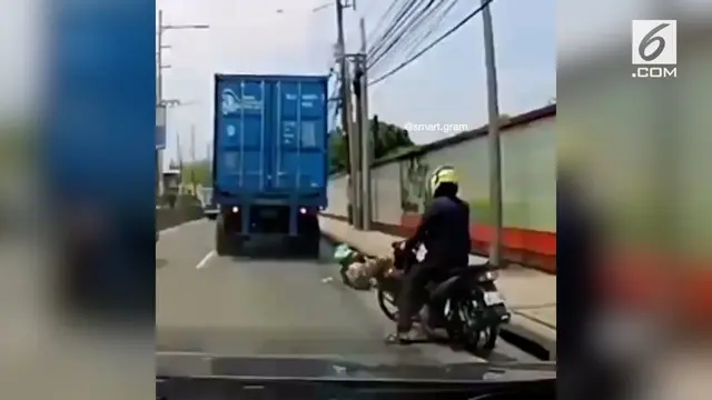 Terekam oleh kamera, seorang pengendara motor yang terlindas sebuah truk dan masih dalam keadaan selamat.