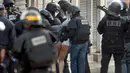 Seorang pria ditangkap oleh petugas keamanan Perancis selama operasi di Saint - Denis, Paris, Perancis, Rabu (18/11/2015). Petugas menangkap buronan atas peristiwa penyerangan pada Jumat malam di Paris lalu.  (REUTERS/Christian Hartmann)