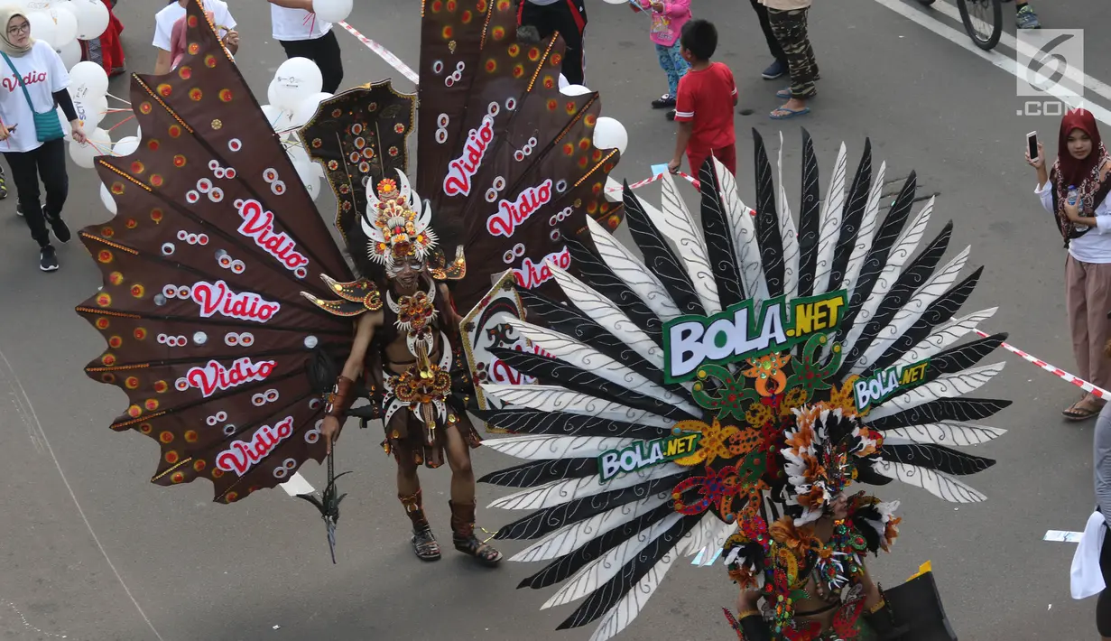 Peserta berkostum Vidio.com dan Bola.net memeriahkan parade Asian Games 2018 di Jalan Thamrin, Jakarta, Minggu (13/5). Tak hanya dari komunitas, peserta parade ini juga datang dari karyawan PT Elang Mahkota Teknologi (Emtek). (Liputan6.com/Arya Manggala)