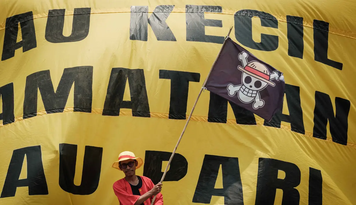 Seorang warga Pulau Pari, Jakarta Utara, berpakaian layaknya tokoh utama anime Jepang One Piece, saat aksi unjuk rasa di depan kantor Kementerian Kelautan dan Perikanan di Jakarta pada Rabu 8 Oktober 2025. (Yasuyoshi CHIBA/AFP)