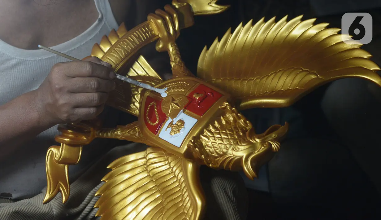 Perajin menyelesaikan kerajinan lambang Garuda Pancasila di bengkel rumahan, Jakarta, (13/8/2020). Menko bidang Perekonomian Airlangga Hartanto memaparkan anggaran Pemulihan Ekonomi Nasional (PEN) dalam bentuk bantuan bagi UMKM tercatat Rp32,5 triliun per 3 Agustus 2020. (merdeka.com/Imam Buhori)